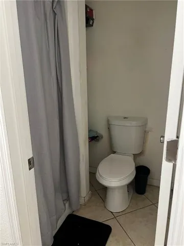 Bathroom featuring tile flooring and toilet
