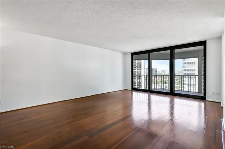 Spacious living room with wood floors.