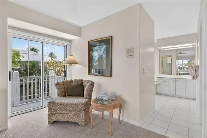 Primary Bedroom sitting area featuring baseboards and light colored carpet