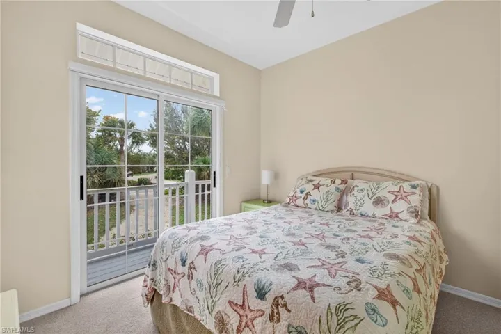 Bedroom featuring light carpet, access to outside, and a ceiling fan