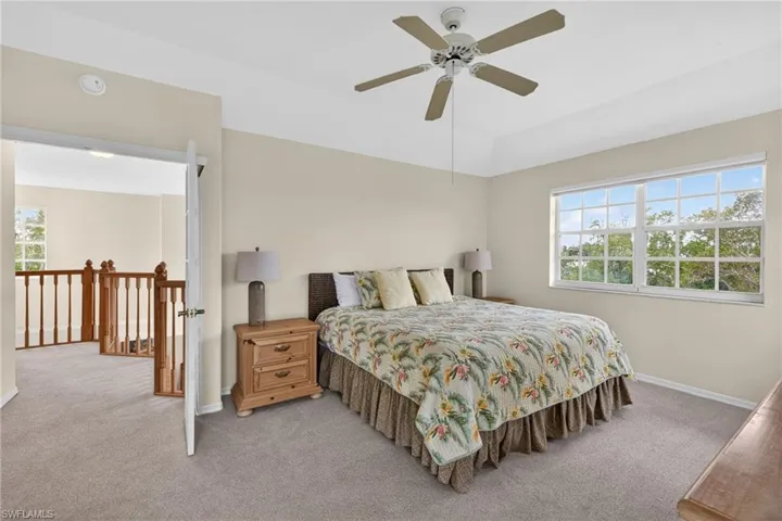 Primary Bedroom featuring light colored carpet and ceiling fan