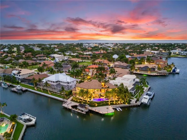 Aerial view at dusk featuring a water view