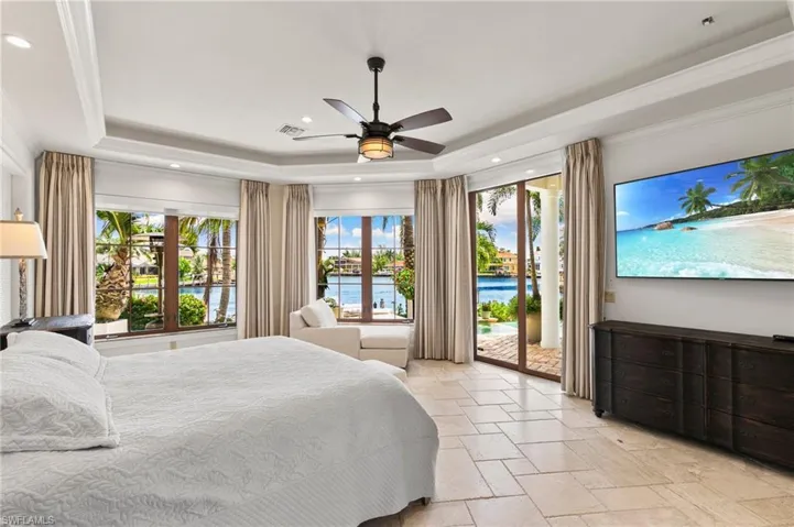 Bedroom featuring access to exterior and water views