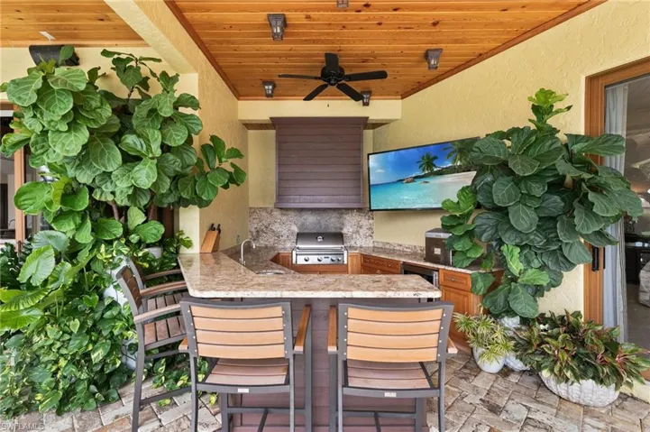View of patio / terrace featuring area for grilling, sink, an outdoor kitchen, and ceiling fan