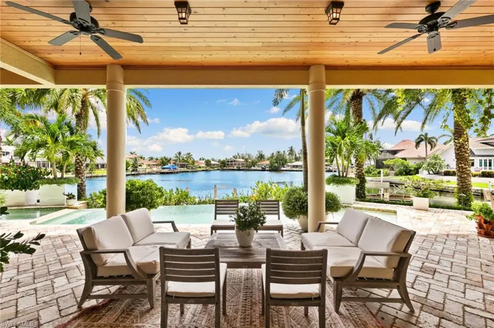 View of patio featuring a water view, wood ceiling, and outdoor lounge area