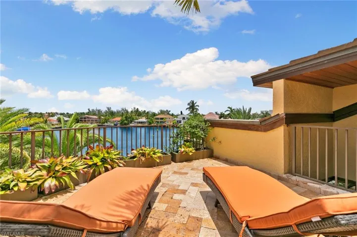 View of 3rd floor, roof level sundeck / terrace with a water view