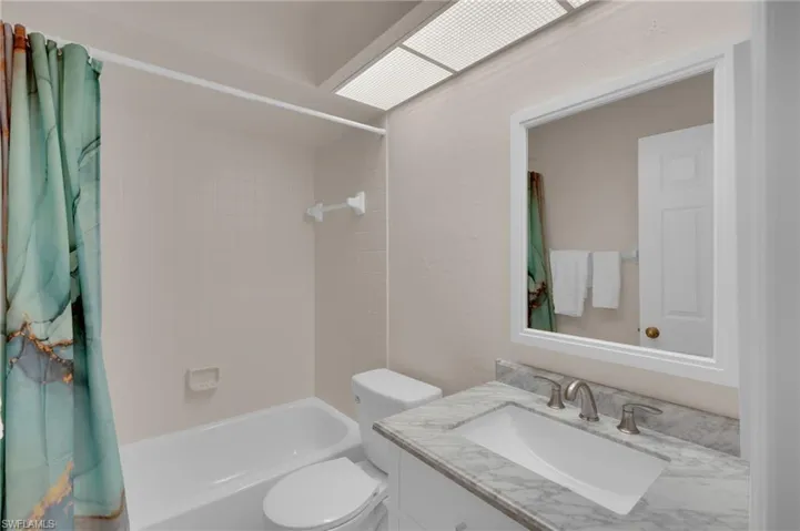 Full bath with vanity and shower / bath combo with shower curtain