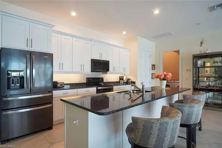Kitchen with upgraded black stainless steel appliances and huge center island