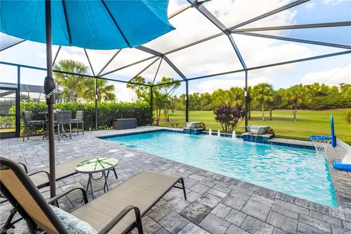 Beautiful salt water pool with water features overlooking the golf course