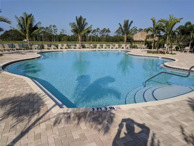 Pool featuring fence and a patio area