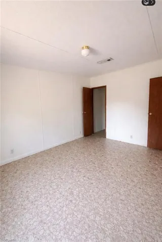 Unfurnished room featuring a textured ceiling