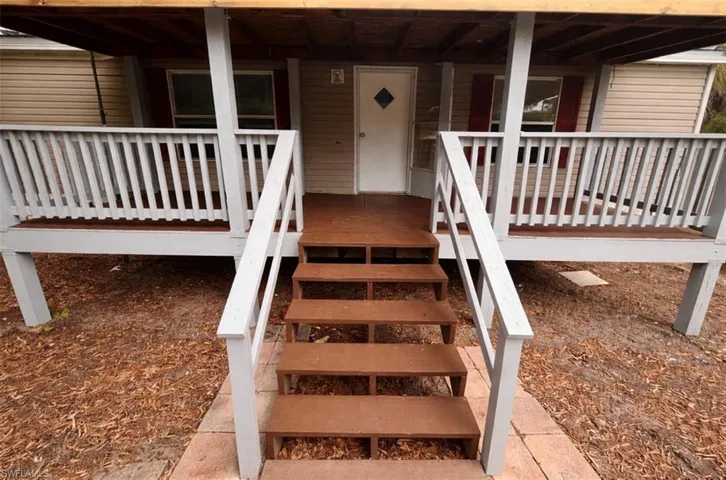 Doorway to property featuring covered porch