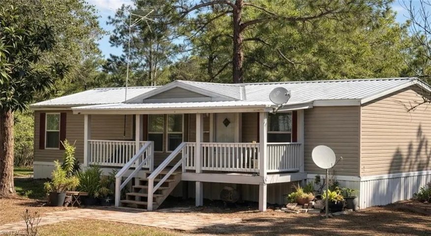 View of front of home featuring covered porch and a metal roof