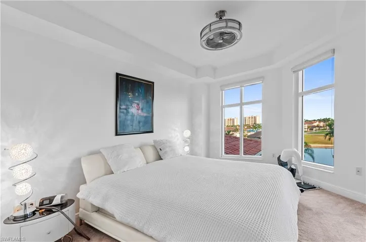 Bedroom with carpet flooring and a water view