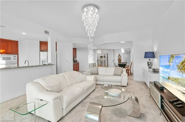Living room featuring recessed lighting, a chandelier, and light colored carpet