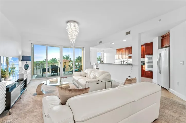 Living area featuring a chandelier, light tile patterned floors, and recessed lighting