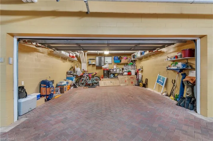 Garage featuring concrete block wall