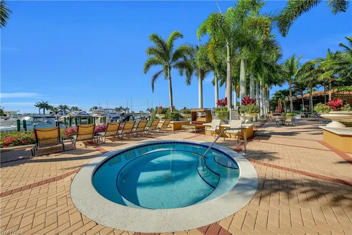 View of swimming pool featuring a patio and a hot tub