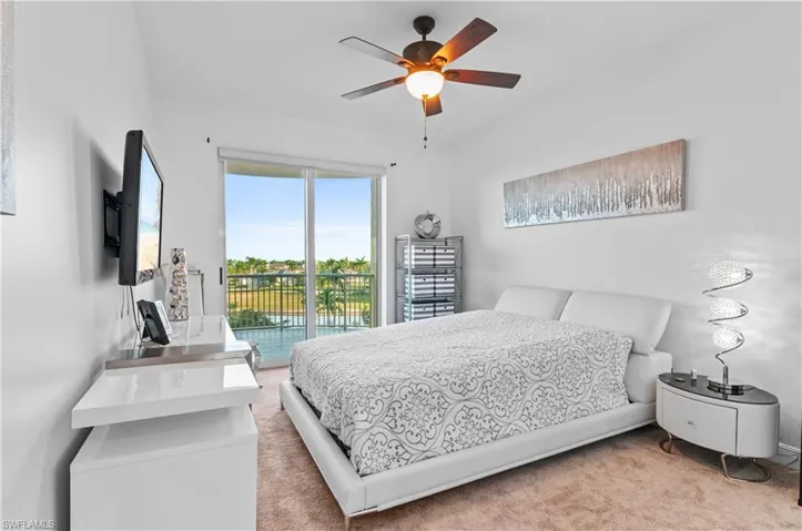 Bedroom featuring access to exterior, carpet, and a ceiling fan