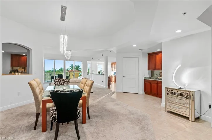 Dining room featuring recessed lighting and light colored carpet