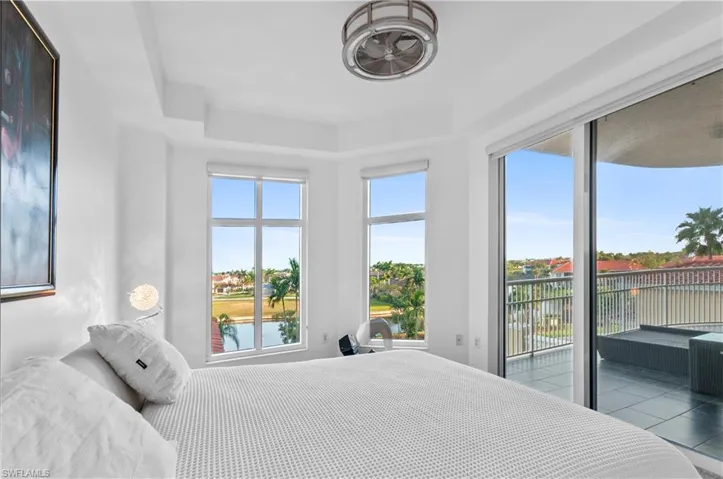 Bedroom featuring a water view and access to exterior