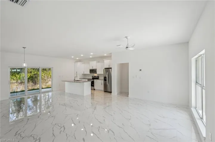 living room featuring light marble finish flooring, a ceiling fan, and recessed lighting