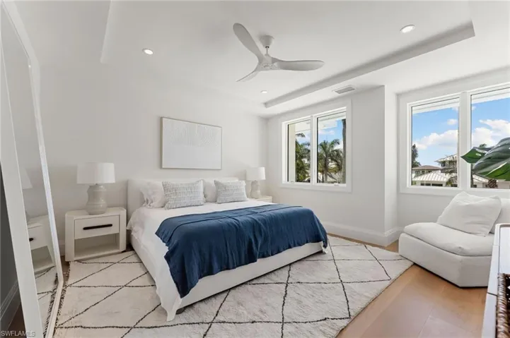 Recessed lighting, ceiling fan, wood-finish flooring, and multiple windows