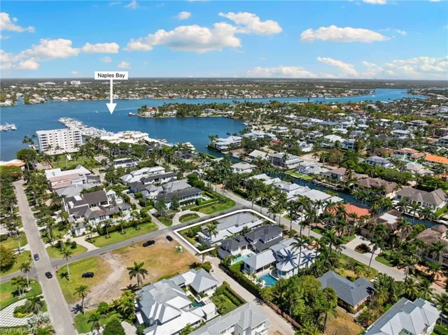 Aerial perspective showcasing extensive waterfront properties and Naples Bay