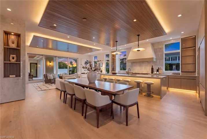 Wood-finish flooring throughout, recessed lighting, and a wood-paneled ceiling with accent lighting