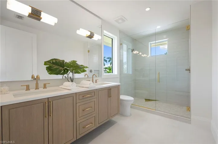 Dual vanity with integrated sinks and gold-tone fixtures