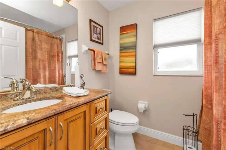 Bathroom with tile patterned floors, toilet, and vanity