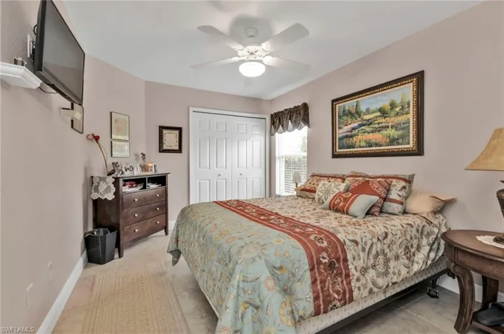 Bedroom featuring ceiling fan and a closet