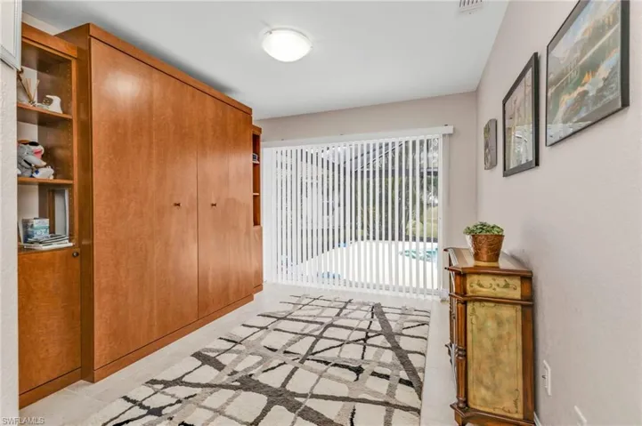 Hallway with light tile patterned floors