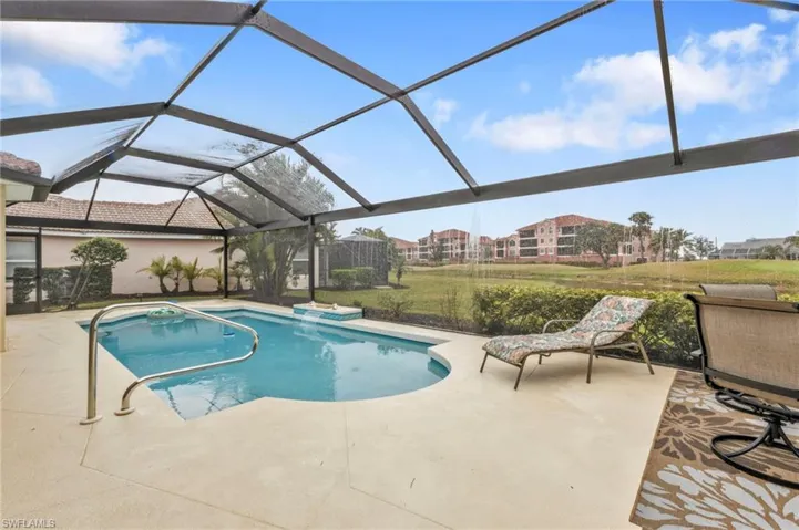 View of swimming pool with a patio and a lanai