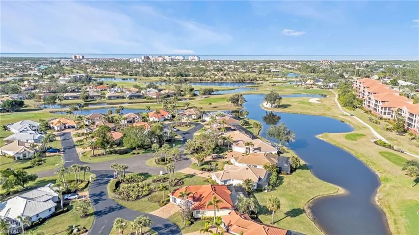 Birds eye view of property with a water view