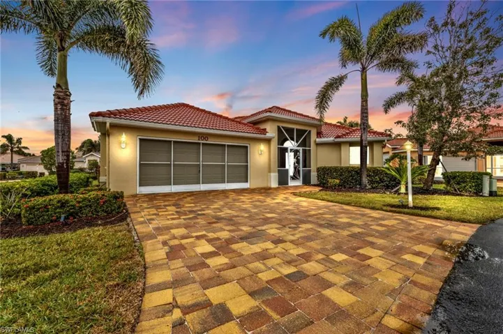 Mediterranean / spanish-style house featuring a garage and a lawn