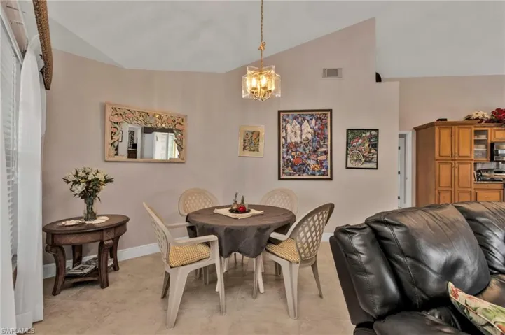 Dining room featuring a chandelier and vaulted ceiling