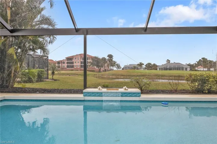 View of swimming pool with a lawn