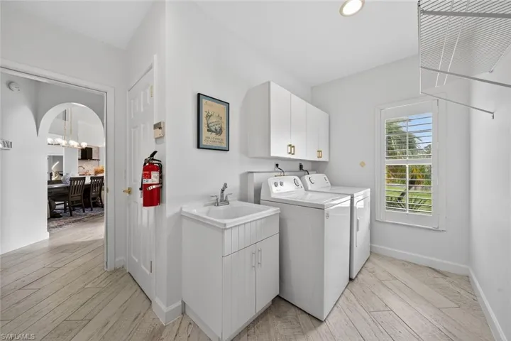 Full laundry room with utility sink