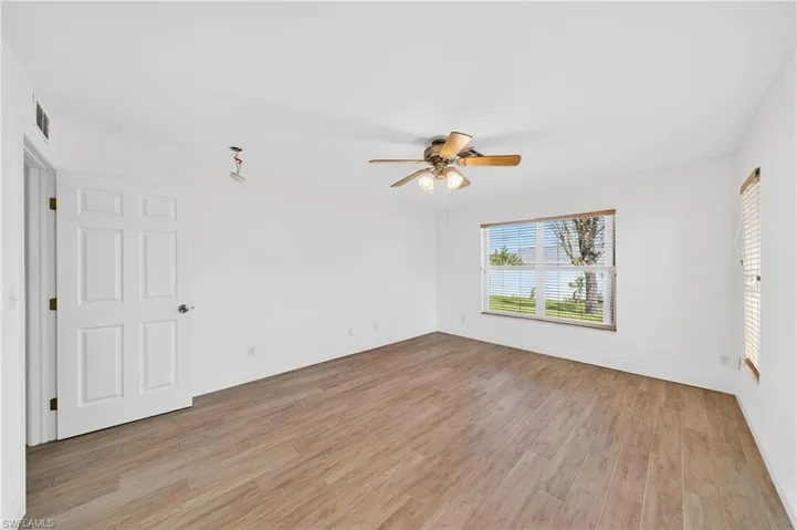 Empty room with light wood-type flooring and ceiling fan