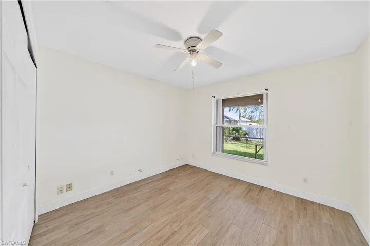 Spare room featuring light wood-style flooring and ceiling fan