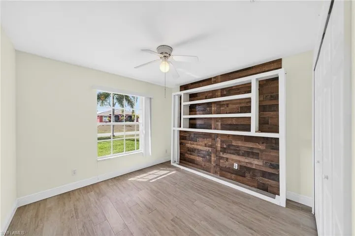 Spare room featuring light wood-style flooring and ceiling fan