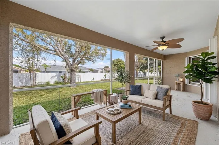 Sunroom with a patio, a ceiling fan, and outdoor furniture