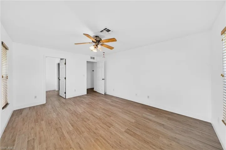 Unfurnished bedroom with light wood finished floors and ceiling fan