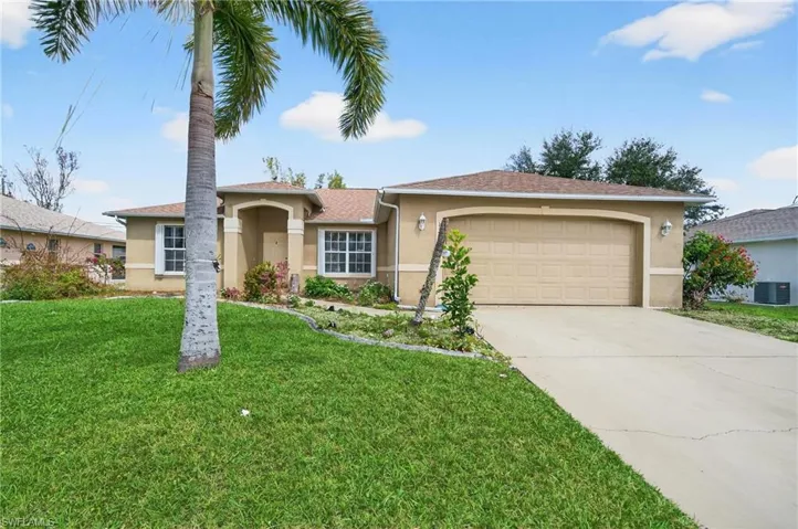 Ranch-style house featuring stucco siding, a garage, driveway, and a front lawn