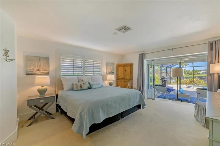 Carpeted bedroom featuring access to exterior and baseboards