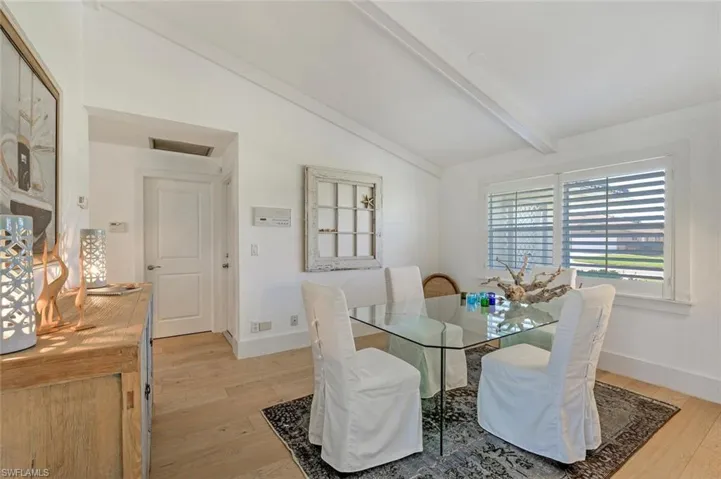 Dining area with light wood-style flooring and baseboards