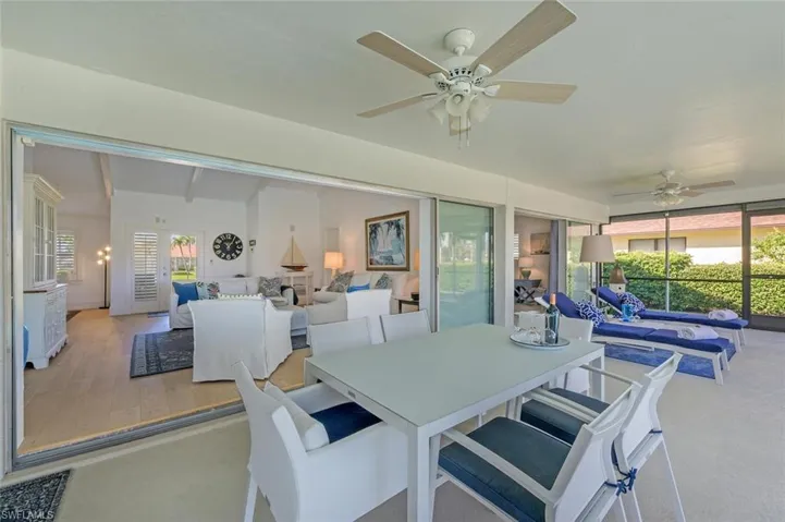 Dining area with a ceiling fan, healthy amount of natural light, and beam ceiling
