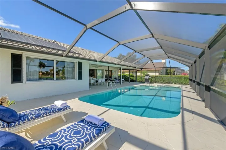 Swimming pool with a patio area, ceiling fan, and a lanai