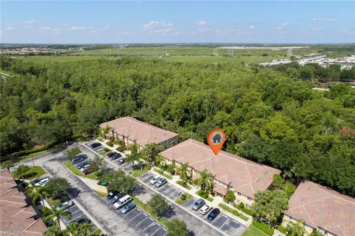 Aerial view of residential area with a nearby body of water and a pool area
